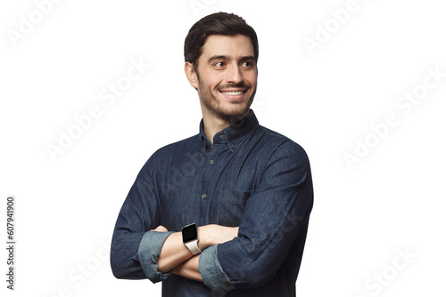 Ambitious young businessman looking away with arms crossed