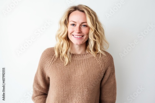 Portrait of a beautiful young woman smiling at camera over white background