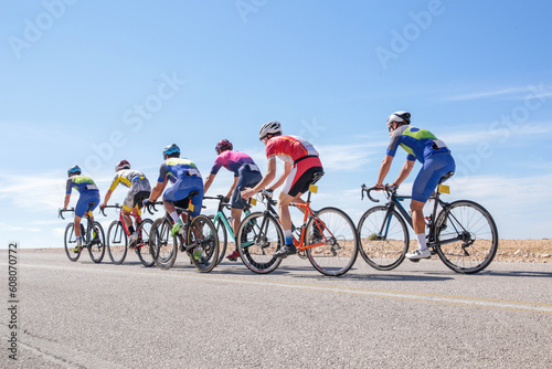 bike bikers race uphill on asphalt road