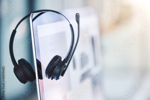 Headset, call center and computer for customer service in an empty office space. Crm, telemarketing and sales or technical support company with headphones and desktop pc for help desk consultation