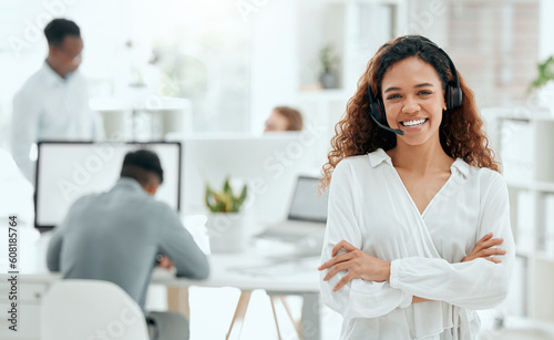 Call center woman, confident portrait and office with arms crossed, leader and pride with team in blurred background. Telemarketing manager, happy and smile for customer service, tech support or crm