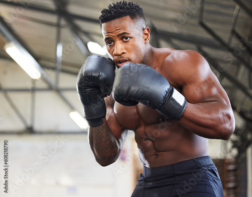 African man, boxing and punch in gym for fitness, focus or training for growth, goal and wellness for competition. African guy, boxer and gloves for exercise, wellness or martial arts club for sports