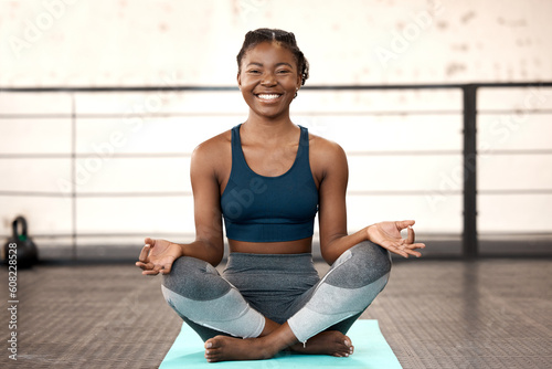Happy black woman, yoga and meditation in gym for spiritual wellness, zen or calm fitness workout. Portrait of African female person or yogi with smile for healthy mind, body and meditating exercise