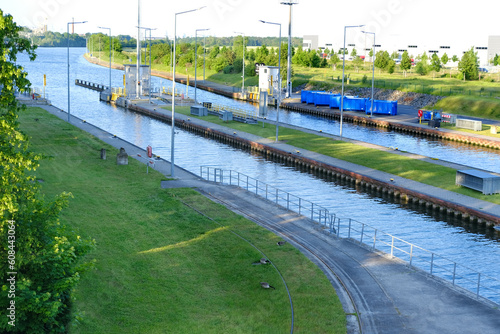 gates, close passage through narrow lock on navigable river Main in Germany, transportation of goods, cargo, ships through shipping channels, lock systems