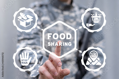 Soldier peacemaker using virtual touchscreen presses inscription: FOOD SHARING. Food sharing military concept. Soldiers charity to share food. Share meal, giving helping hand to poor or refugees.