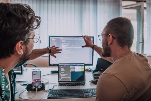 Programmers engrossed in deep collaboration, diligently working together to solve complex problems and develop innovative mobile applications with seamless functionality.