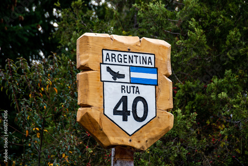 Wooden sign indicating Route 40 with pine trees as a background