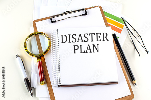 DISASTER PLAN text on notebook with clipboard on white background