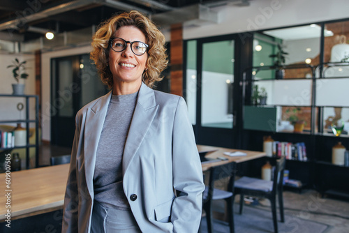 Portrait of a professional woman in a suit. Business woman standing in an office