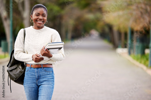 Black woman, books and portrait of student at college, university or person ready for learning, goals or education. Girl, face and happy learner studying on campus or walking outdoor with backpack
