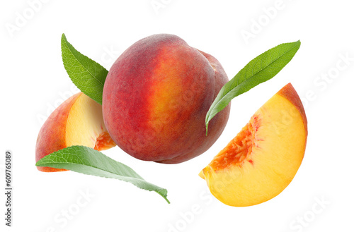 Juicy fresh peaches with green leaves falling on white background
