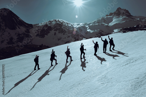 mountaineer team reaching the summit and simultaneously raising their arms and saluting