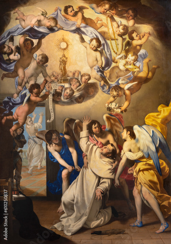 NAPLES, ITALY - APRIL 23, 2023: The painting of Eucharistic vision of St. Thomas Aquinas in the church Basilica di Santa Maria della Sanita by Giovan Francesco De Rosa (1607 – 1656).