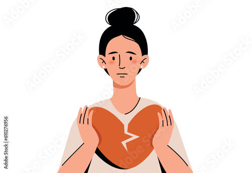 Girl holding a broken heart with her hands. The concept of disappointment in love, dislike for oneself, non-recognition by society.