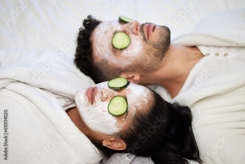 Facial, spa and relax with couple and mask for skincare, cosmetics and detox treatment. Beauty, face and self care weekend with man and woman in bedroom at home for salon, wellness and cucumber