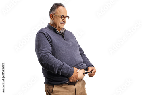 Mature man using an insulin pen in belly