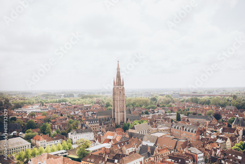 aerial view of terracotta roofs and tall church buildings in an old european city belgium europe belltower