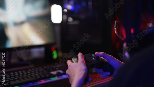 Hand of female cyber hacker gamer holding controller joystick to playing games on computer