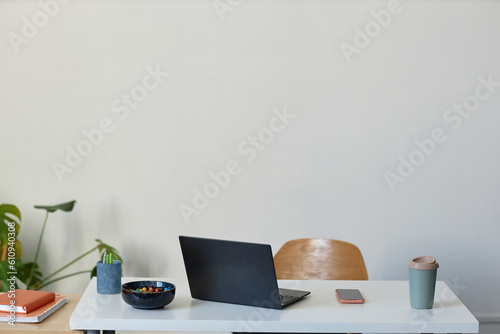 Minimal background image of simple workplace with laptop on white, copy space