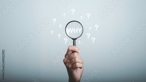 Why question in magnifying and question mark be around, What is your reason concept. Business answer and analysis, problem ask, interrogation, research information with copy space on grey background.