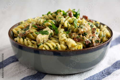 Homemade Chicken Spinach Alfredo Rotini Pasta in a Bowl, side view.