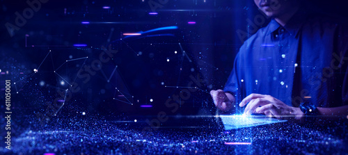 Digital information technology concept. Man use cybersecurity computers to protect against online threats. Data Analytics or Data Science. Binary code, polygons and particles on dark blue background.