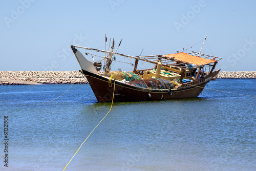 Traditional wooden dhow boat in the port city of Al Ashkhara. Sultanate of Oman