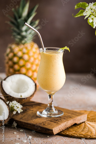 Pina colada pineapple cocktail or Lassi on a rustic wooden table