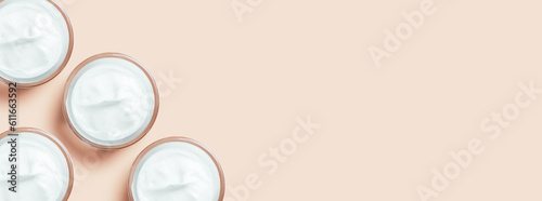 set of jars of cream in white on a beige background.