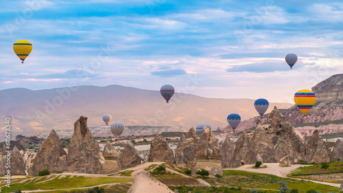 Cappadocia. Hot air balloons flying over Cappadocia in a dramatic sky. Travel to Turkey. Selective focus included.