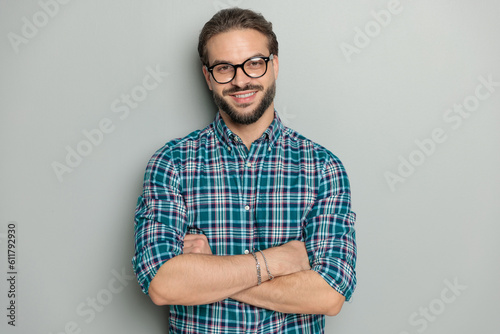 happy nerd man with glasses crossing arms and smiling