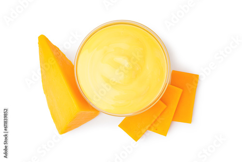 Bowl with tasty cheddar sauce and chunks of cheese on white background