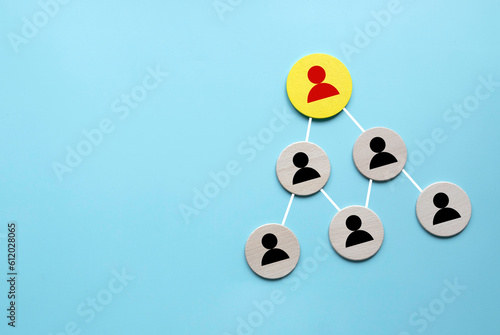 Company hierarchical organizational chart of wooden circle on blue background with copy space.