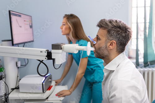 Man performing pulmonary function test and spirometry using spirometer at medical clinic. Spirometry of lungs