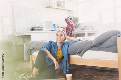 Female college student relaxing on bedroom floor