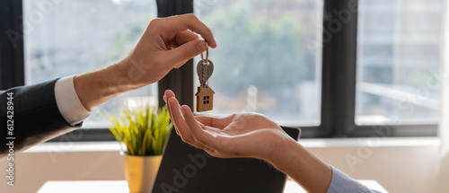 lease, rental and selling home. Real estate agent manager smile holding key for new owner. rent house, Sales, loan credit financial, insurance, Seller, dealer, installment, buy, sell, move in