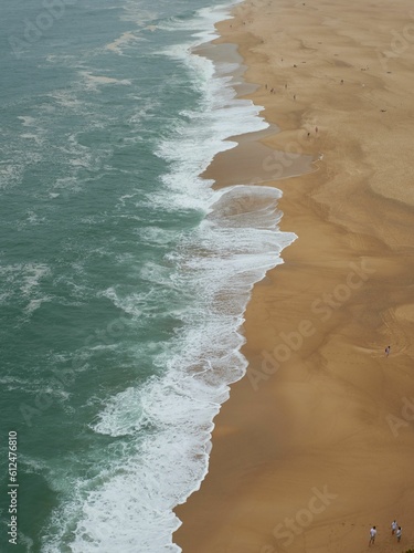 Aerial view of an empty beach foamy waves crashing on the sand - great for backgrounds