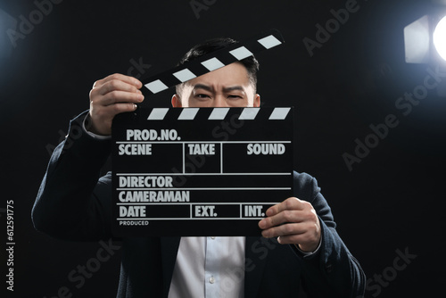 Asian actor with clapperboard on stage. Film industry
