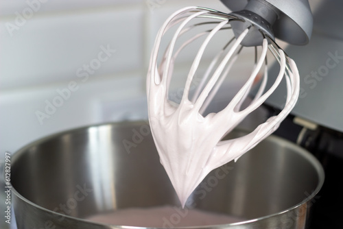 Stainless steel pot and whisk with whipped cream