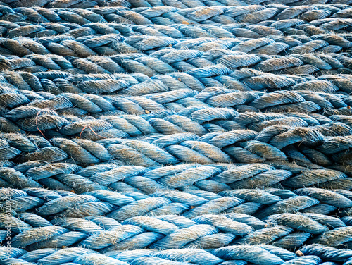 Nylon blue towing rope prepared and laying ready for towing operations on aft station of cargo vessel