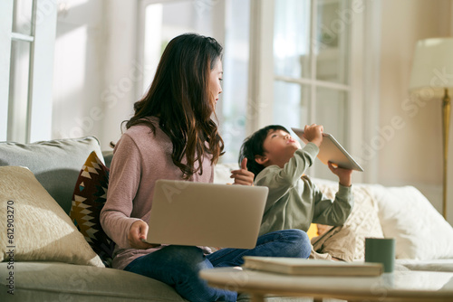 young asian mother and hyperactive child at home