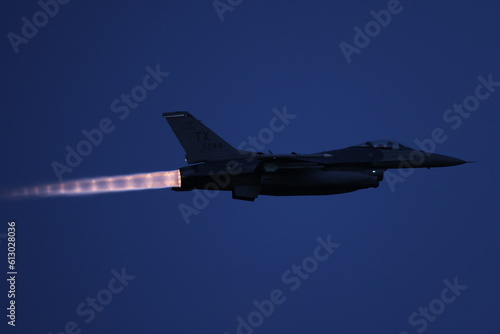 f16 fighter jet with afterburners at night. 