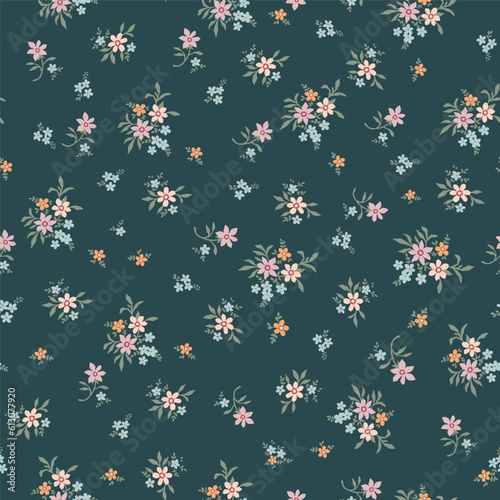 Fashionable pattern with small flowers on a green background. Seamless botanical print with various floral elements. A collection of vintage textiles for fabric and wallpaper.