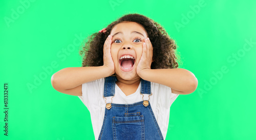 Shocked, surprise and child hands on face screaming and excited, happy and winning isolated in a studio green screen background. Portrait, young and kid with surprised facial expression due to news