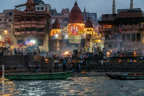 India Varanasi ganga ghat at night, view of the crowded banks of people and funeral pyres