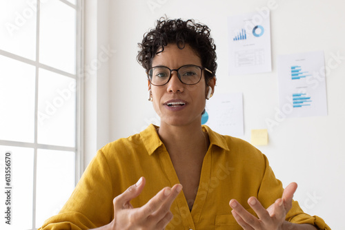 Woman discussing with her business team over a video call