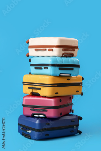 Stack of suitcases on blue background