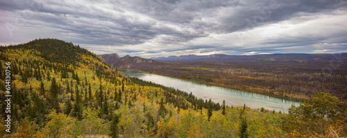 Landscape with Yukon river in autumn colors under overcast sky, Yukon territory Canada