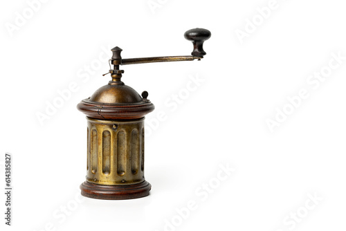 Old fashioned coffee grinder isolated on a white background; vintage coffee grinder on a white background with copy space; hand operated vintage coffee grinder close up.