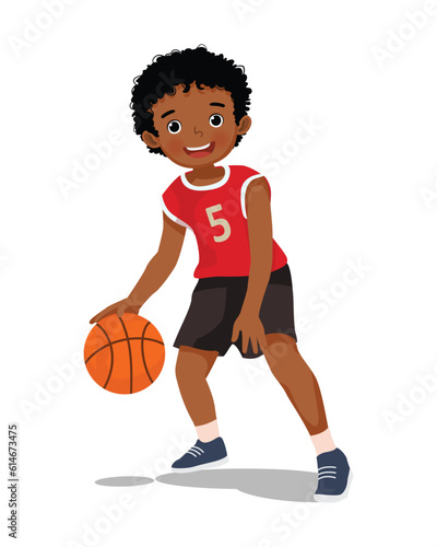 Cute little African boy with sportswear playing basketball dribbling the ball in action